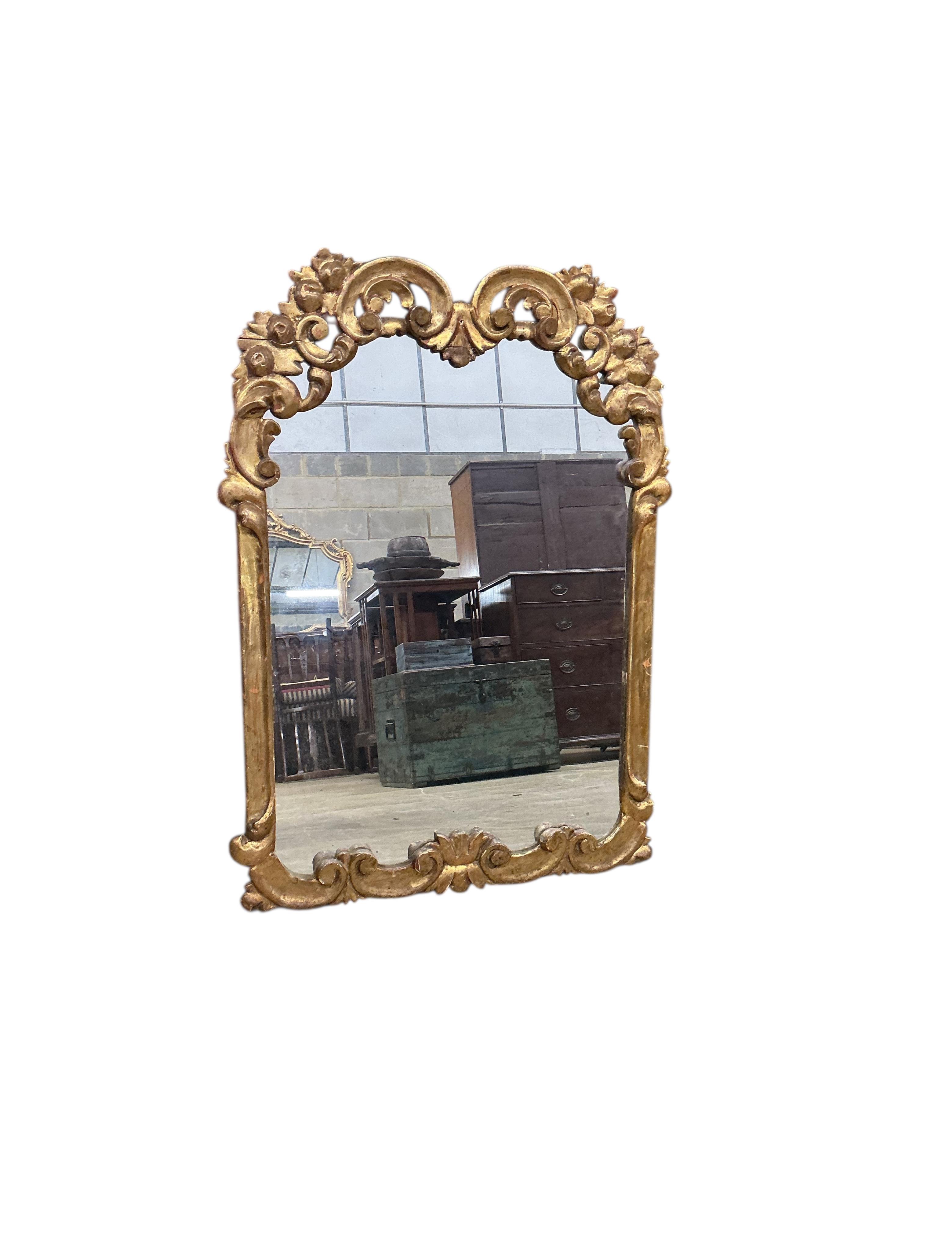 An 18th century style carved giltwood wall mirror, width 64cm, height 89cm